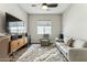 Spacious living room with tile floor, large TV, and a plush rug, creating a comfortable and inviting atmosphere at 22743 N 97Th Dr, Peoria, AZ 85383