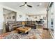 Open-concept living room features a comfortable sectional sofa and flows into the kitchen at 22743 N 97Th Dr, Peoria, AZ 85383