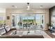 Bright living room featuring sliding glass doors to the backyard, hardwood floors, and ceiling fan at 22743 N 97Th Dr, Peoria, AZ 85383