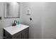 Contemporary half bathroom with a gray vanity, white sink and neutral decor at 23945 N Pablo N Ct, Sun City, AZ 85373