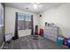 Versatile room with carpeted floor, window, and gym equipment, perfect for workout or recreation at 23945 N Pablo N Ct, Sun City, AZ 85373