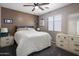Bedroom with a ceiling fan, carpeted floor, and a window with blinds at 23945 N Pablo N Ct, Sun City, AZ 85373