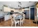 Dining area with hardwood floors, white cabinets, and stainless steel appliances at 23945 N Pablo N Ct, Sun City, AZ 85373