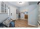 Inviting entryway with wood floors, bench seating, and decorative wall decor at 23945 N Pablo N Ct, Sun City, AZ 85373