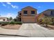 Two story home with a tile roof, covered porch, and two car garage at 23945 N Pablo N Ct, Sun City, AZ 85373