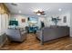 Comfortable living room with wood floors, ceiling fan, and plenty of seating at 23945 N Pablo N Ct, Sun City, AZ 85373