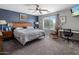 Primary bedroom featuring a ceiling fan, neutral colors, and a window at 23945 N Pablo N Ct, Sun City, AZ 85373
