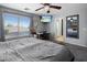 Primary bedroom with a ceiling fan, ensuite bathroom, and a mirror at 23945 N Pablo N Ct, Sun City, AZ 85373