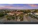 Wide aerial view showcasing the property's landscaping, gated entrance, and neighborhood setting at 24695 S 195Th Way, Queen Creek, AZ 85142