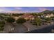 An elevated view of the home with mature trees, desert landscaping, and mountain views at 24695 S 195Th Way, Queen Creek, AZ 85142