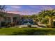 Expansive backyard featuring a pool, lush landscaping, and a putting green for recreation at 24695 S 195Th Way, Queen Creek, AZ 85142
