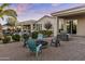 Entertain outdoors with multiple seating areas, a gas fire pit, outdoor kitchen, and mature trees at 24695 S 195Th Way, Queen Creek, AZ 85142