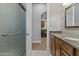 Bathroom showcases a glass door shower, granite countertops, and dark wood cabinets at 24695 S 195Th Way, Queen Creek, AZ 85142