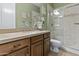 Bathroom with wood cabinets, quartz counters, and a glass-enclosed shower at 24695 S 195Th Way, Queen Creek, AZ 85142