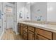 Bright bathroom features double sinks, wood cabinets, and an open doorway to the shower at 24695 S 195Th Way, Queen Creek, AZ 85142