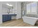 Bright bathroom features a modern soaking tub, glass enclosed shower, and dual sink vanity at 24695 S 195Th Way, Queen Creek, AZ 85142