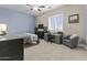 Inviting bedroom with natural light, a functional desk area and comfortable chair at 24695 S 195Th Way, Queen Creek, AZ 85142