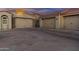 Spacious driveway leading to a three-car garage with arched windows and stone accents at 24695 S 195Th Way, Queen Creek, AZ 85142