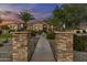 Stone pillars framing a walkway leading to a meticulously landscaped front yard and home entrance at 24695 S 195Th Way, Queen Creek, AZ 85142