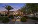 Charming single-story home with a tile roof, arched windows, lush landscaping, and inviting curb appeal at 24695 S 195Th Way, Queen Creek, AZ 85142