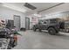 Spacious garage featuring a car, motorcycle and ample space for storage, and an American flag on the wall at 24695 S 195Th Way, Queen Creek, AZ 85142