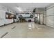 Spacious garage with high ceilings, car lift, storage cabinets, and epoxy flooring for the ultimate car enthusiast at 24695 S 195Th Way, Queen Creek, AZ 85142