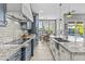 Open-concept kitchen with granite countertops and views of the dining area and backyard at 24695 S 195Th Way, Queen Creek, AZ 85142