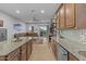 A well-equipped kitchen that opens to a comfortable living space and a covered patio at 24695 S 195Th Way, Queen Creek, AZ 85142