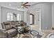 Spacious living room with plush seating, ceiling fan, and arched entryway leading to a foyer at 24695 S 195Th Way, Queen Creek, AZ 85142