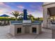 Custom outdoor kitchen with built in BBQ, tile counters, and ample storage space at 24695 S 195Th Way, Queen Creek, AZ 85142