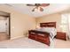 This bedroom showcases a decorative rug, spacious layout, and a ceiling fan at 25862 N 108Th Ave, Peoria, AZ 85383