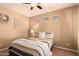 Bedroom featuring a queen bed, neutral colored walls, three horizontal windows, and ceiling fan at 25862 N 108Th Ave, Peoria, AZ 85383