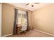 Bedroom featuring neutral colored walls, a desk, one large window and a ceiling fan at 25862 N 108Th Ave, Peoria, AZ 85383