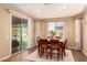 Sunlit dining room with sliding glass doors leading to outdoor pool at 25862 N 108Th Ave, Peoria, AZ 85383