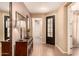 Welcoming foyer with wood-look tile flooring, decorative mirror and cabinet at 25862 N 108Th Ave, Peoria, AZ 85383