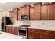 Updated kitchen with stainless steel appliances, stone countertops, and decorative backsplash at 25862 N 108Th Ave, Peoria, AZ 85383