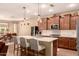 Well-equipped kitchen with a center island, modern appliances, and seamless flow to dining area at 25862 N 108Th Ave, Peoria, AZ 85383