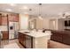 Bright kitchen showcasing a large island with quartz countertops, stainless steel appliances, and modern pendant lighting at 25862 N 108Th Ave, Peoria, AZ 85383