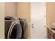 Laundry room showcasing modern appliances, white door, sink and neutral walls at 25862 N 108Th Ave, Peoria, AZ 85383
