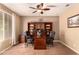 Comfortable home office featuring built-in bookcases, a ceiling fan, and neutral walls at 25862 N 108Th Ave, Peoria, AZ 85383