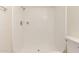 Close-up of shower with white tile and toilet in the bathroom at 27 W Concorda Dr # 104, Tempe, AZ 85282