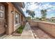 Inviting home entrance featuring a secure gate, fresh landscaping, and walkway to the front door at 27 W Concorda Dr # 104, Tempe, AZ 85282