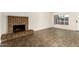 Living room with classic fireplace, tile floors, and a bright window view at 27 W Concorda Dr # 104, Tempe, AZ 85282