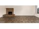 Spacious living room showcasing tile floors and a charming brick fireplace at 27 W Concorda Dr # 104, Tempe, AZ 85282