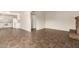 Open-concept living space with tile floors and a cozy brick fireplace at 27 W Concorda Dr # 104, Tempe, AZ 85282