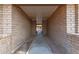 This walkway features brick walls and a concrete floor at 27 W Concorda Dr # 104, Tempe, AZ 85282