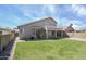 Sprawling backyard with lush lawn, covered patio, upper balcony, and block fence for optimal privacy at 2806 E Pontiac Dr, Phoenix, AZ 85050
