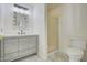 Bright bathroom featuring a vanity with drawers, decorative mirror, and a walk-in shower with glass door at 2806 E Pontiac Dr, Phoenix, AZ 85050