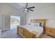 Bedroom featuring wood bed frame, ceiling fan, carpet, and french doors that lead to a covered balcony at 2806 E Pontiac Dr, Phoenix, AZ 85050
