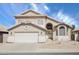 Charming two-story home featuring neutral stucco, an arched entryway, and a well-manicured front yard at 2806 E Pontiac Dr, Phoenix, AZ 85050